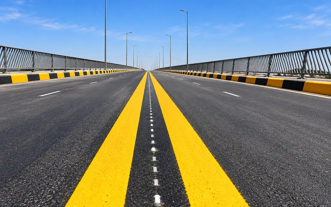 Dual carriageway carried on a viaduct, with fresh yellow road markings